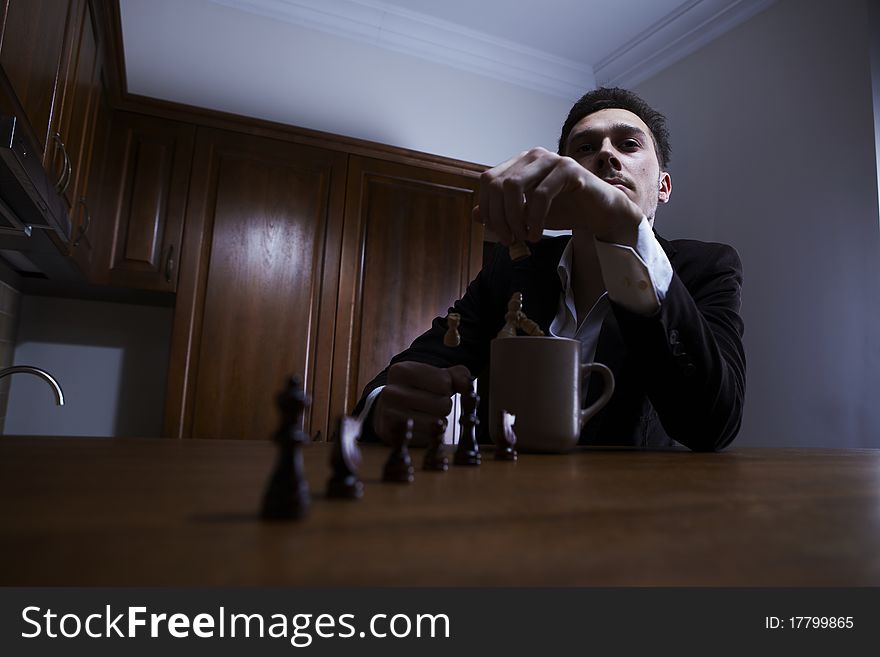 Thoughtful man throwing chess in the cup. Photo.