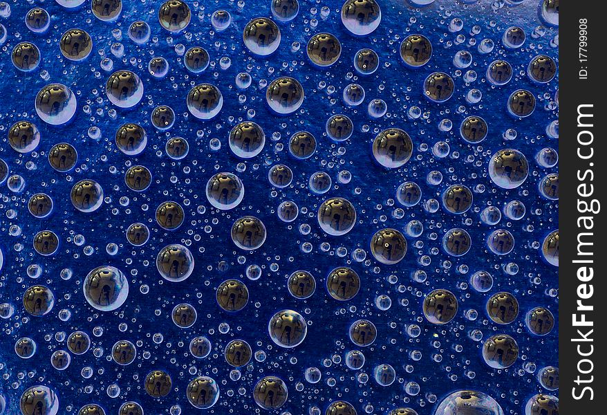 Water droplets on a blue background macro shot. Water droplets on a blue background macro shot
