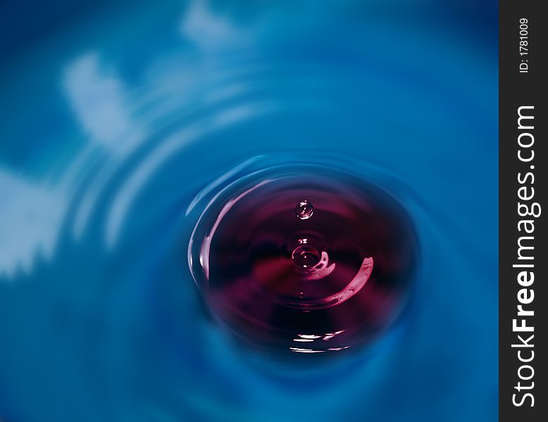 Abstract with dark magenta water drop close-up. Abstract with dark magenta water drop close-up