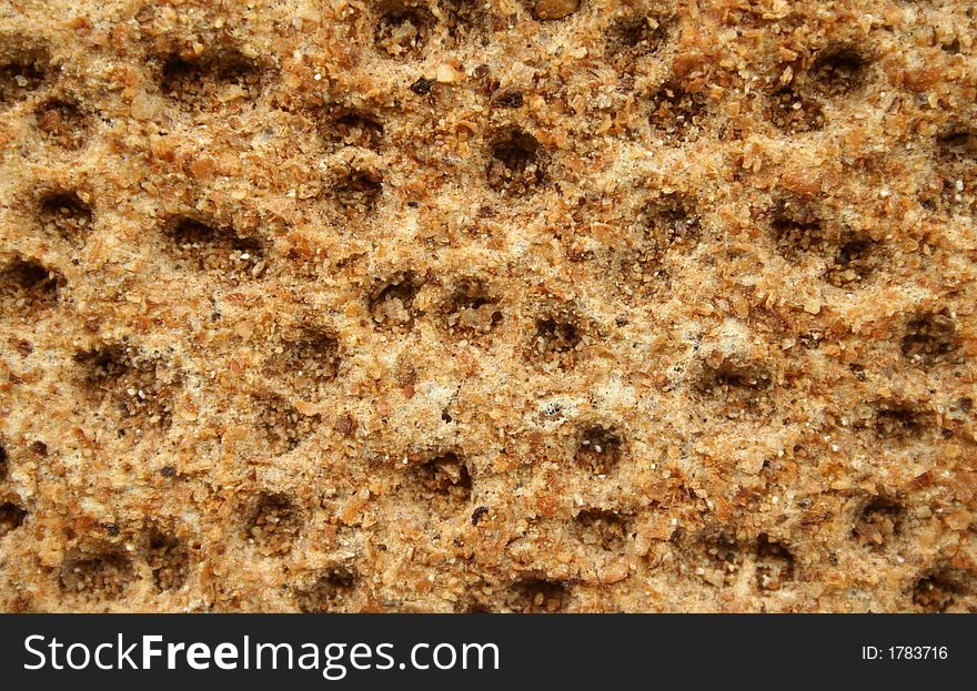 Roughly textured surface of a rye cracker. Roughly textured surface of a rye cracker.