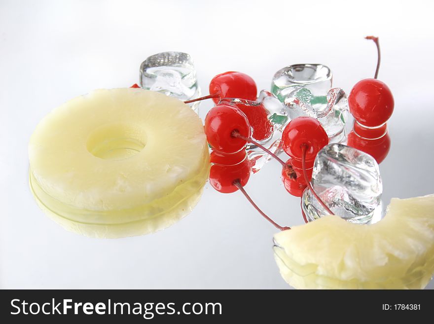 Group of four  cherries, ice cubes and ananias. Group of four  cherries, ice cubes and ananias