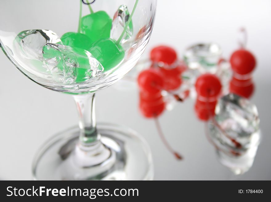 Group of green and red cherries with ice cubes