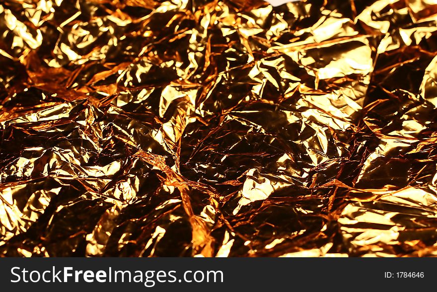 Crashed golden foil for background in macro