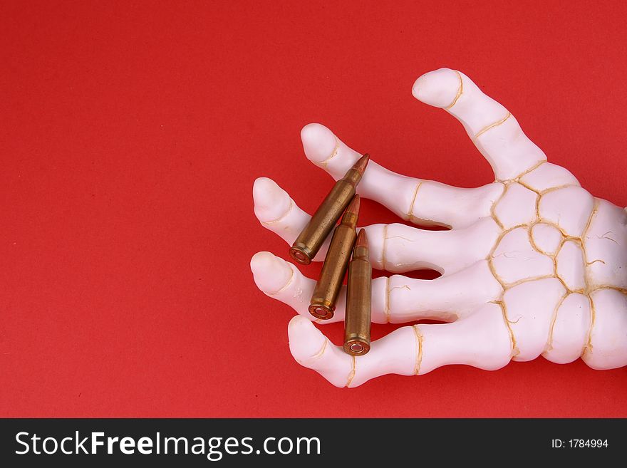 Hand of Death holding machine gun ammunition. Hand of Death holding machine gun ammunition.