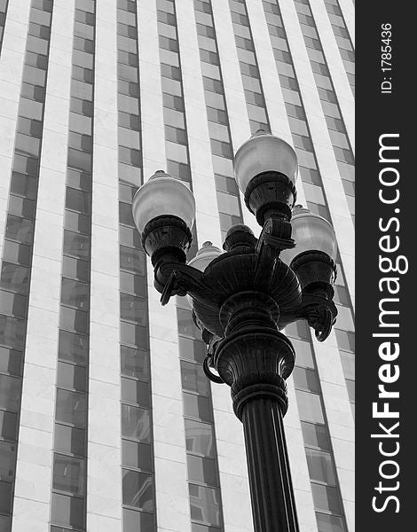 Street Lamp with Glass and Concrete Building in the Background. Street Lamp with Glass and Concrete Building in the Background