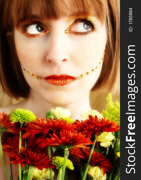 Beautiful 30 something woman with fall flower bouquet and artistic make-up. Beautiful 30 something woman with fall flower bouquet and artistic make-up.