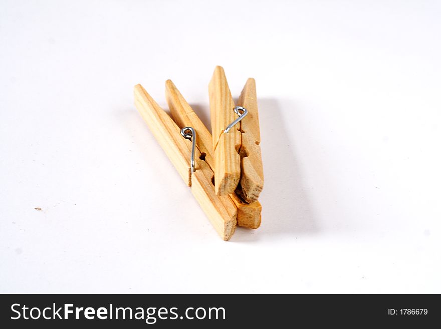 A couple of clothes pins on white background