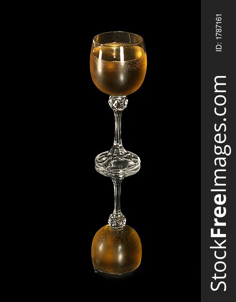 A glass of sparkling wine isolated on black background, 300 Watt halogen lamp lighting. A glass of sparkling wine isolated on black background, 300 Watt halogen lamp lighting