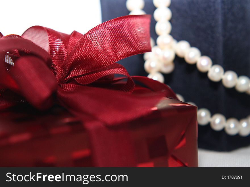 Chic woman gifts over white with focus on red box. Chic woman gifts over white with focus on red box