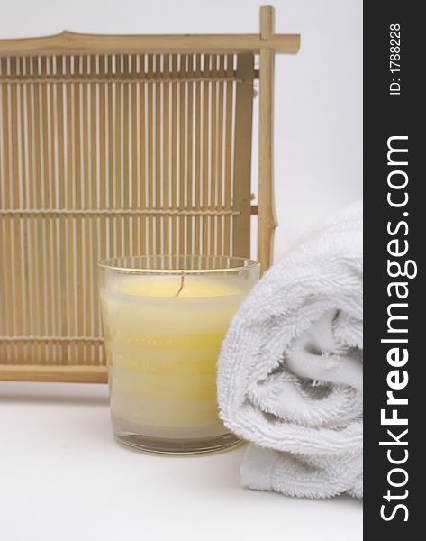 Relaxing scented candle with white towel to show clean and pure bathroom treatment. Relaxing scented candle with white towel to show clean and pure bathroom treatment