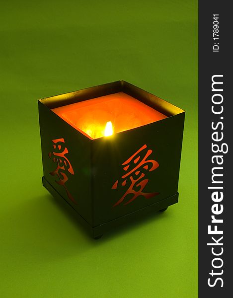 Candle with hieroglyph on green