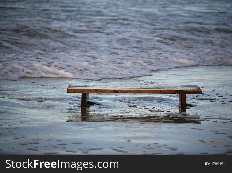 Wooden bench worth in the sea