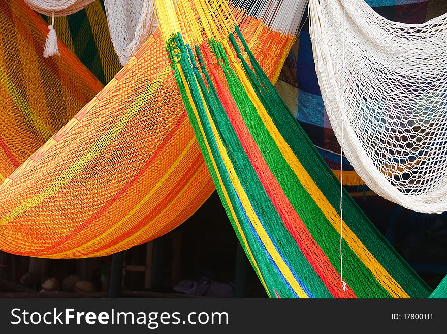 Details of colorful hammocks in a Mexican market.