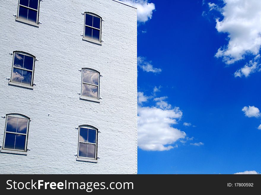 Cloudy Windows on white building