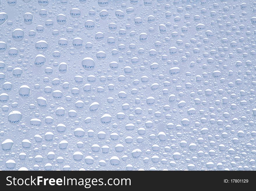 Water text refracted in drops of water ideal as a background. Water text refracted in drops of water ideal as a background.