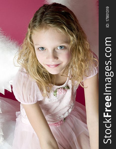 Beautiful little angel girl with wings and pink dress