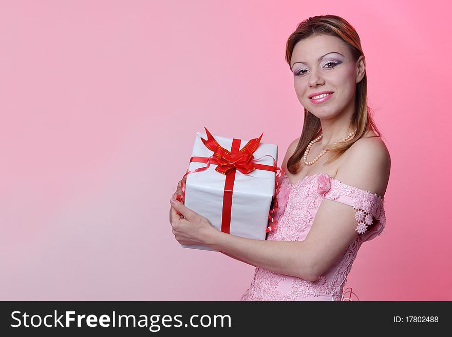 Happy girl with gift box over white