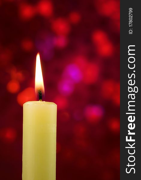 Single lit candle on red abstract back ground. Single lit candle on red abstract back ground
