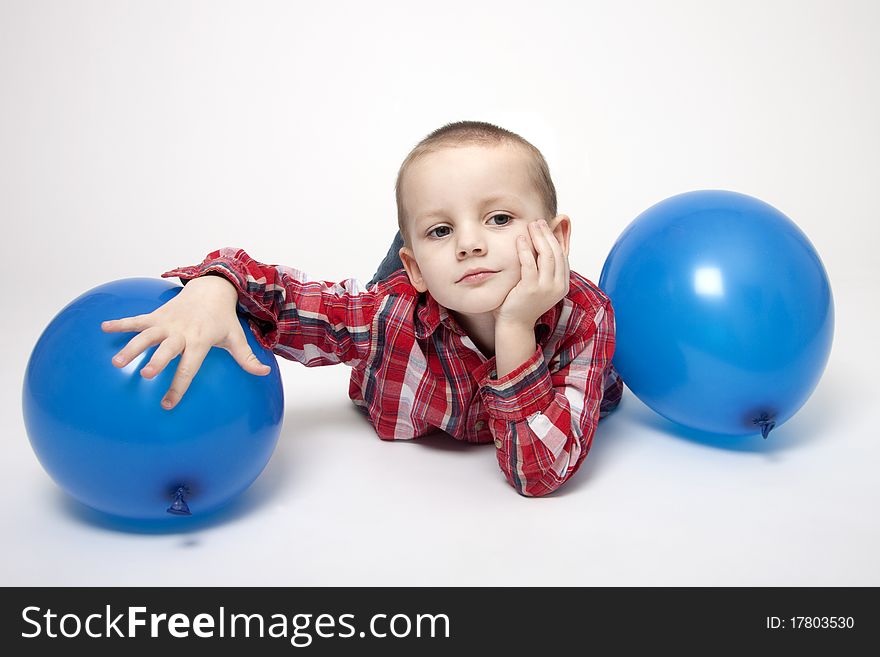 Portrait Of Cute Boy With Blue Balloons