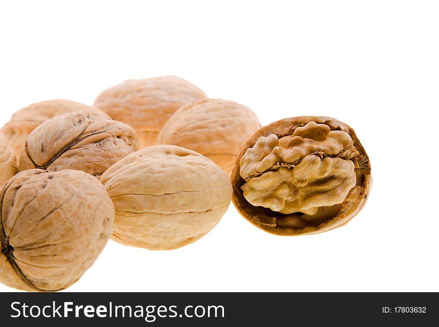 Some walnuts, one of which are split (On a white background, Focus on an open nut)