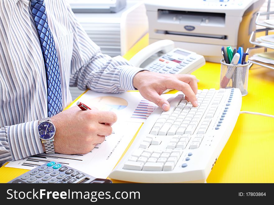 Male hands typing on a white keyboard