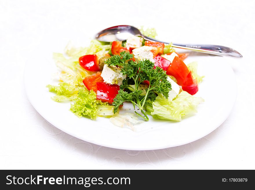 Greek salad on the white plate