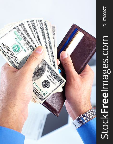 Male hands holding a wallet and money us dollars.