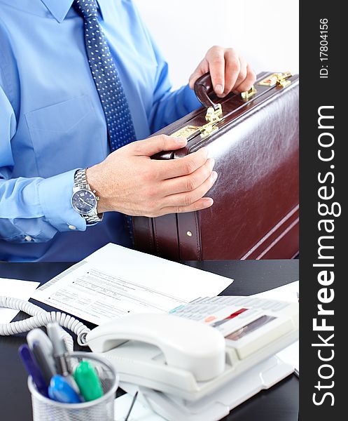 Businessman holding a brown case. Businessman holding a brown case