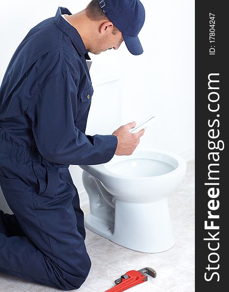 Plumber repairing a flush toilet