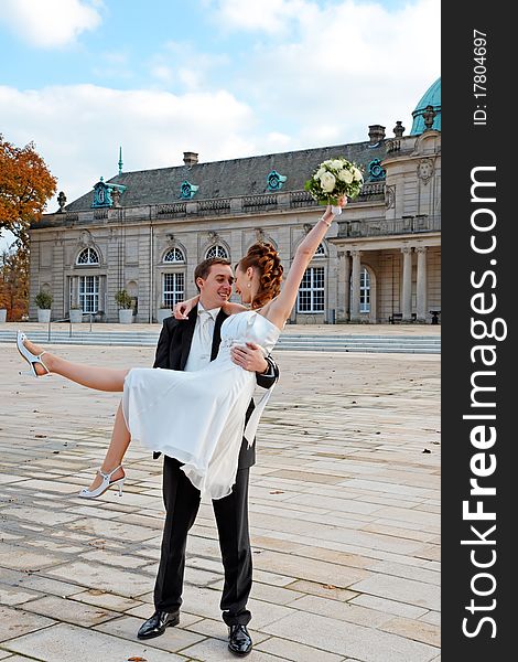 The happy young couple. Groom holding bride in his arms. The happy young couple. Groom holding bride in his arms.