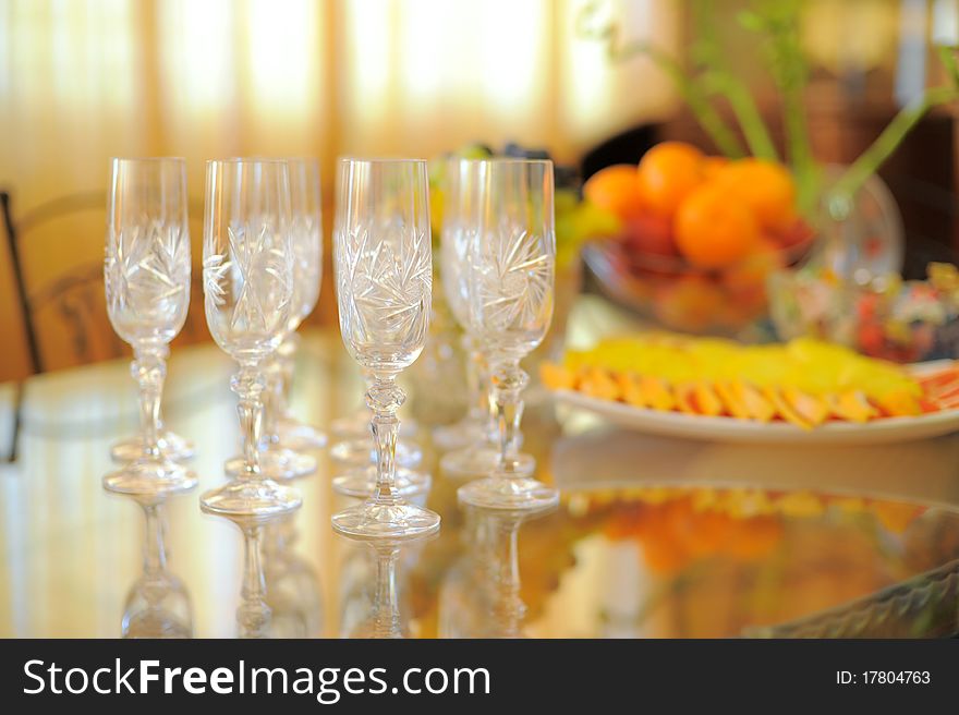 Empty glasses on the glass table in orange light