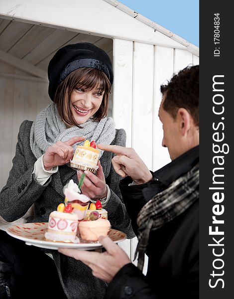 Portrait Of A Couple Enjoying Pastry Outdoors