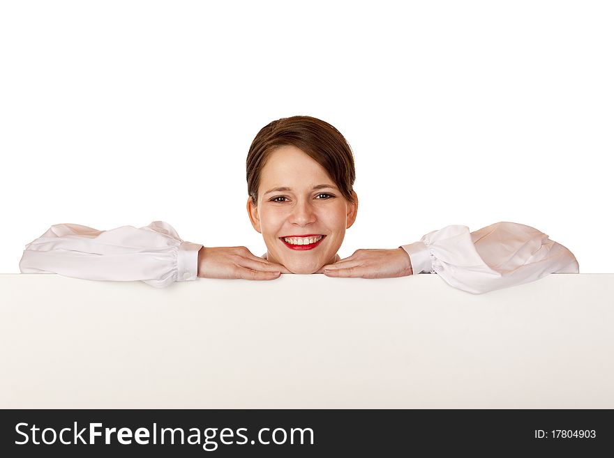 Young happy woman leans on blank billboard. Isolated on white background.