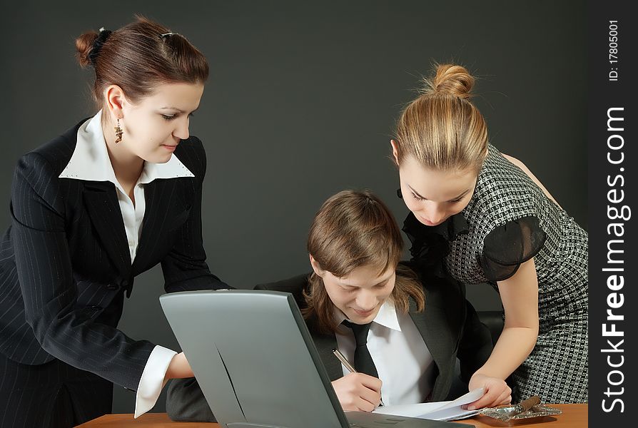 The young businessman and two secretaries hold meeting