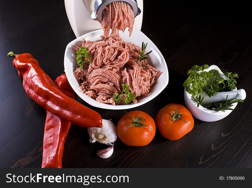 Bowl of mince with electric meat grinder and vegetables. Bowl of mince with electric meat grinder and vegetables