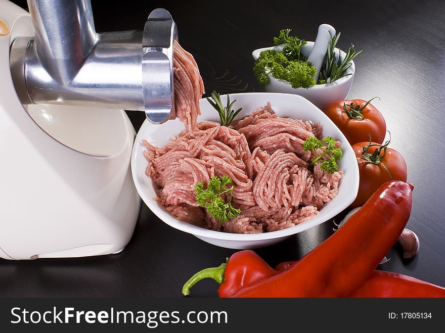 Meat grinder with mince and vegetables