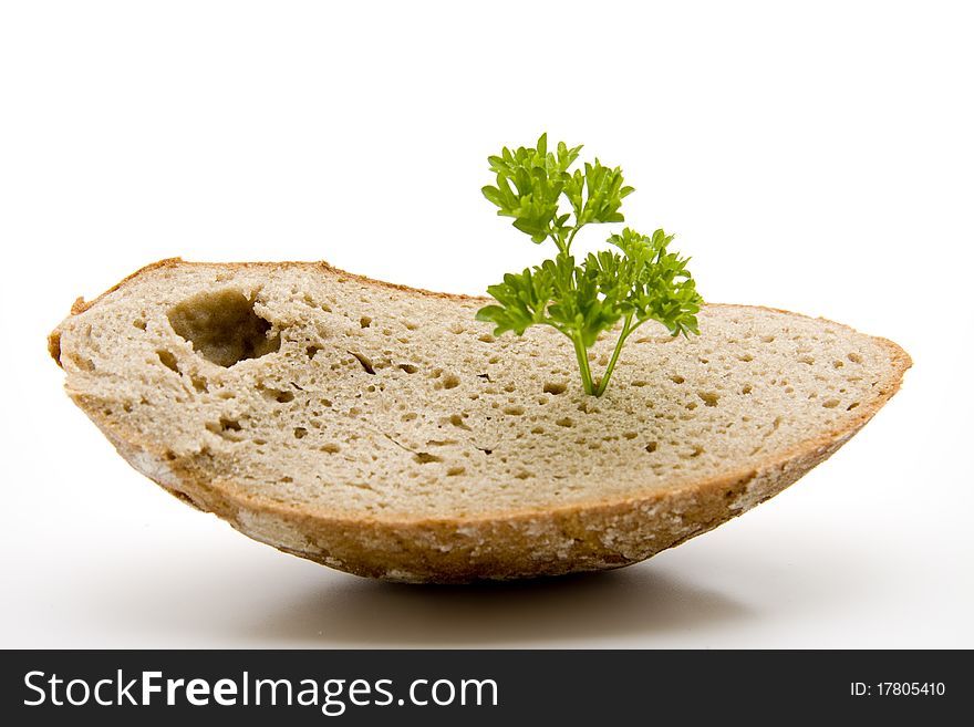 Fresh bread cut with parsley onto white background. Fresh bread cut with parsley onto white background