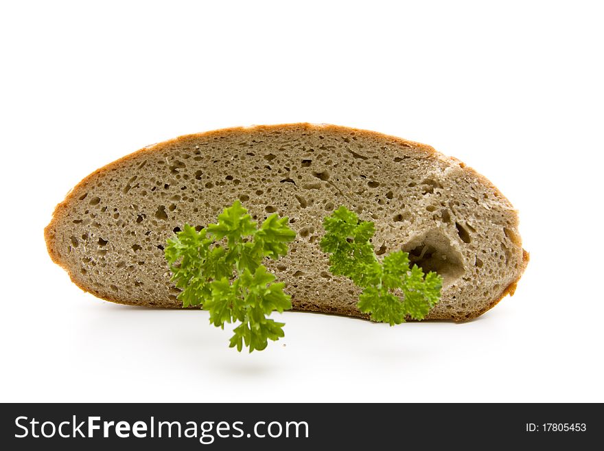 Fresh bread cut with parsley onto white background. Fresh bread cut with parsley onto white background