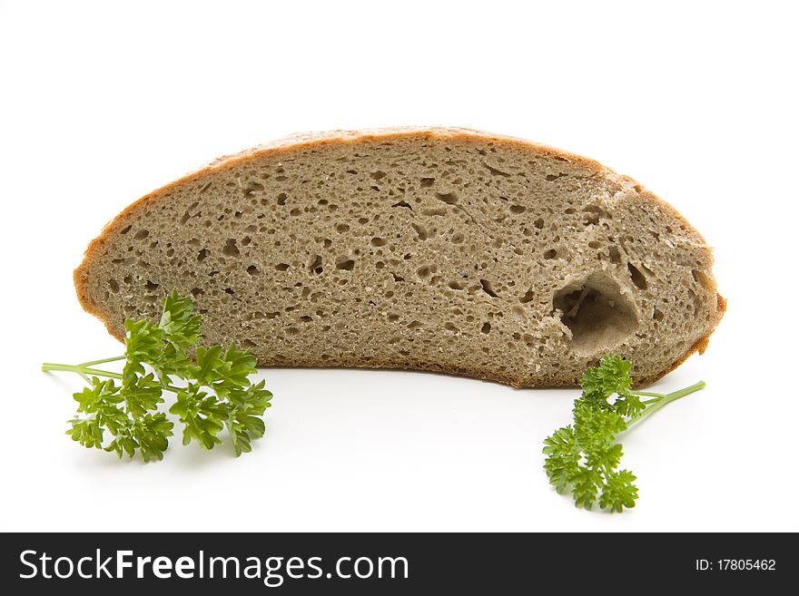Fresh bread cut with parsley onto white background. Fresh bread cut with parsley onto white background