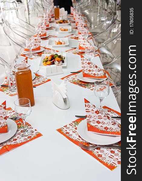 Catering table set with silverware, napkins and glasses at restaurant before party