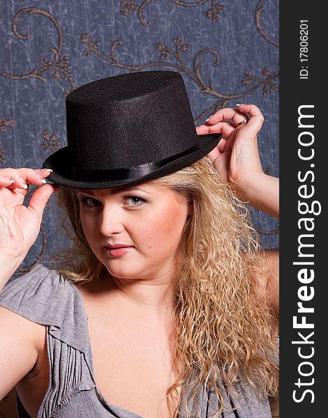 Charming young woman in a hat looking at camera. Charming young woman in a hat looking at camera
