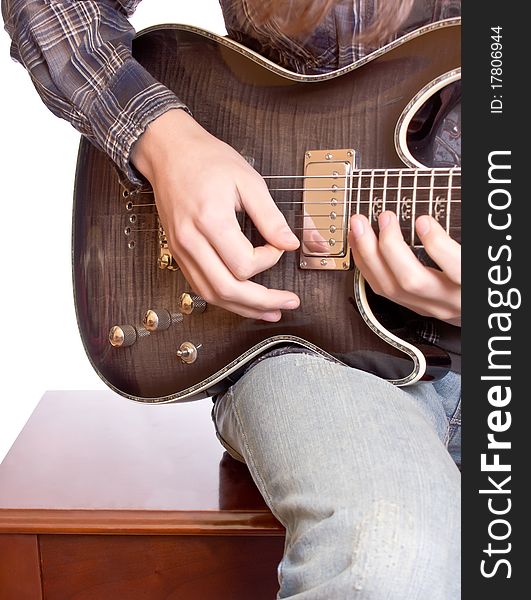 Guitarist playing against white background