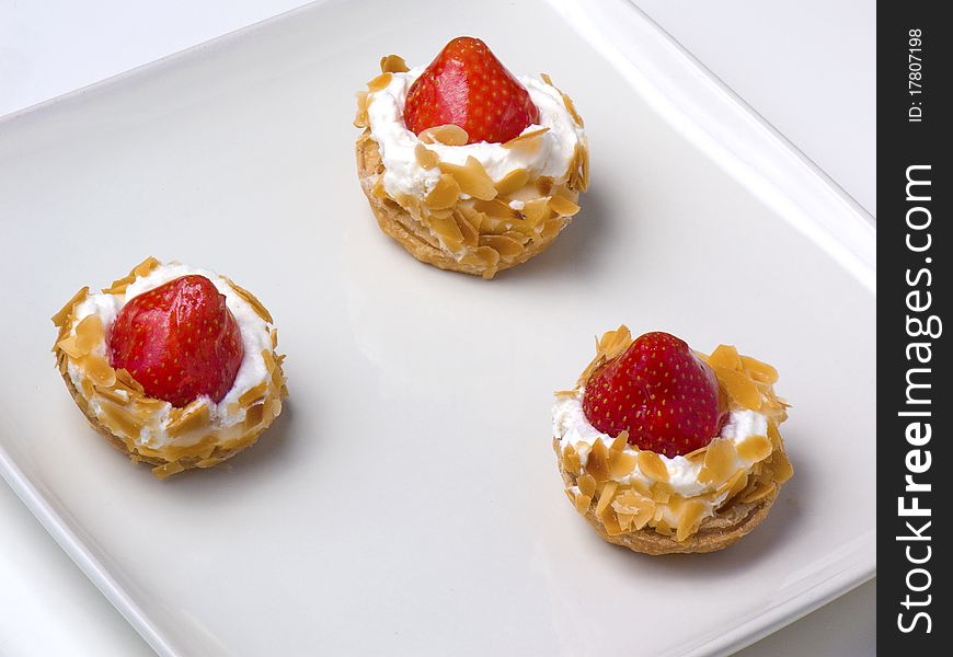 Strawberry tarts on a sqare plate