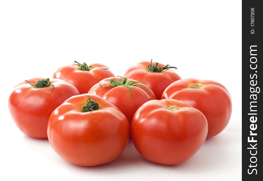 Seven fresh shiny tomatoes isolated on white background