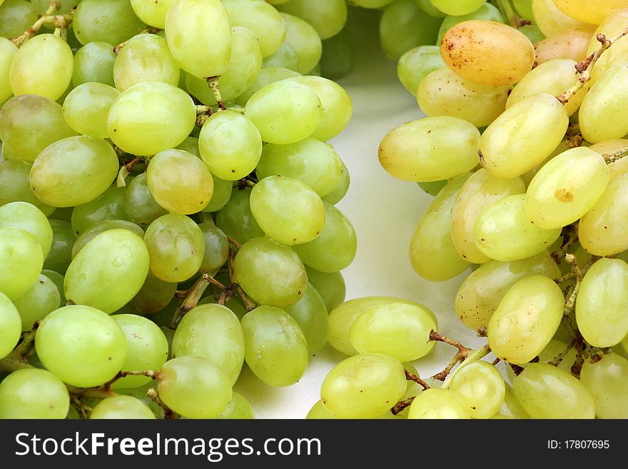 Closeup of a large cluster of green grapes.