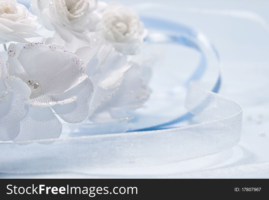 White flowers from a wedding on blue background with blue and white ribbon. White flowers from a wedding on blue background with blue and white ribbon