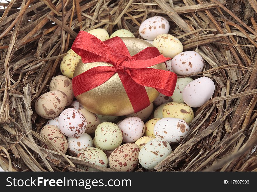 Golden eggs in bird nest over white background. Golden eggs in bird nest over white background