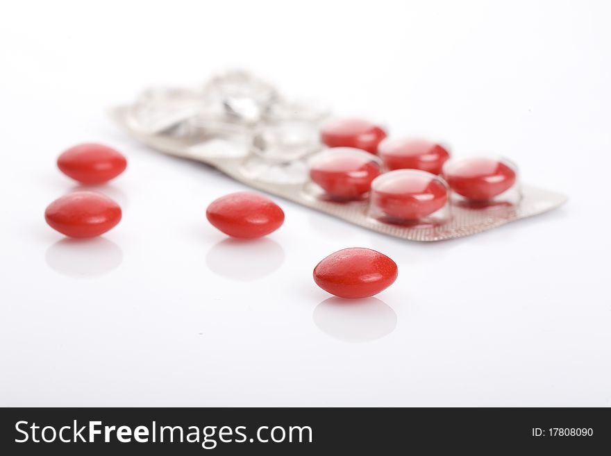 Red pills isolated on white background