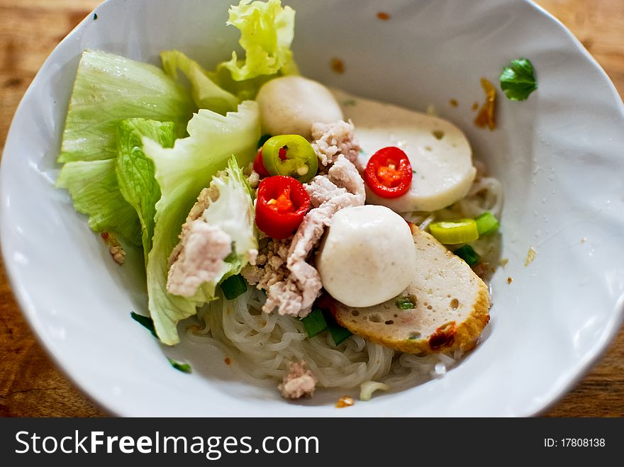 Asian style noodle with pork , fish ball and vegetables