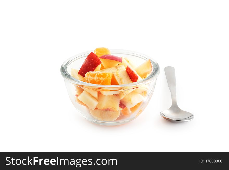 Healthy breakfast consisting of fruit salad in the bowl and a spoon isolated on white with clipping path. Healthy breakfast consisting of fruit salad in the bowl and a spoon isolated on white with clipping path